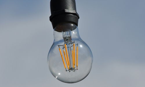 Glass LED Filament Light Bulb attached to a Black pendant fitting, switched off