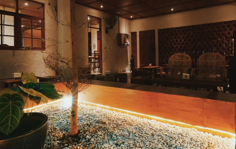 LED Strip Lights in the garden illuminating a modern plant wooden plant bed filled with white stones