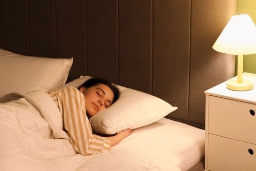Person Sleeping With a Lamp on
